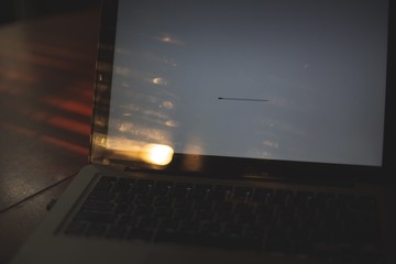 laptop on table with loading bar,dark tone 