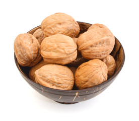 walnuts in wooden bowl on white background