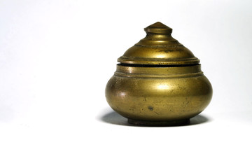 Isolate photo of ancient small brass circular box with screw cap with space for write wording, value container usually use in old generation to store lip grease or tradition lip balm.