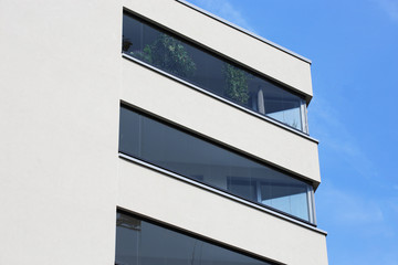 Modern apartment building with glazed balconies