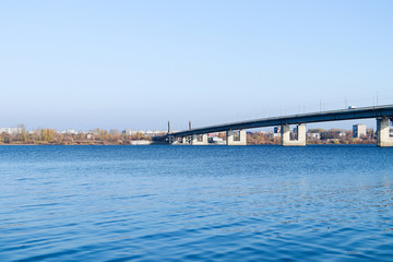 Obraz premium Autumn day in Arkhangelsk. View of the river Northern Dvina and automobile bridge in Arkhangelsk.