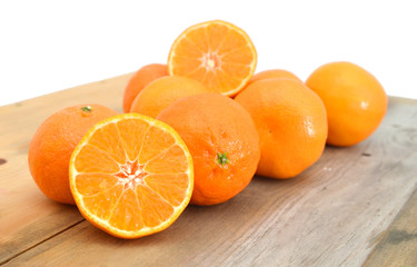 orange mandarines heap on wooden board