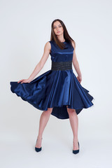 Fototapeta premium Portrait of the beautiful brunette girl in long blue dress