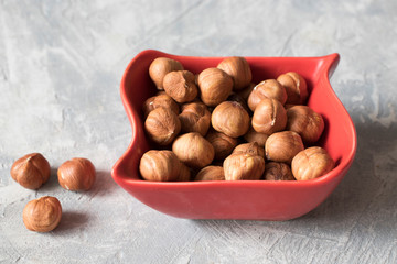 Healthy food and snack. nuts, hazelnuts in a red bowl
