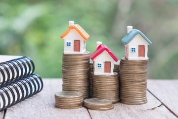 Mini house on stack of coins,Money and house, Real estate investment, Save money with stack coin, Mortgage concept.