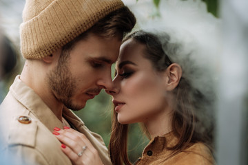 happy lovers boyfriend and girlfriend kissing, hugging in the garden