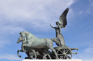 A statue of a goddess on a charriot