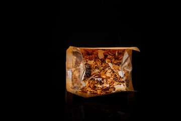 top view on granola with coconut and raisins in open craft bag