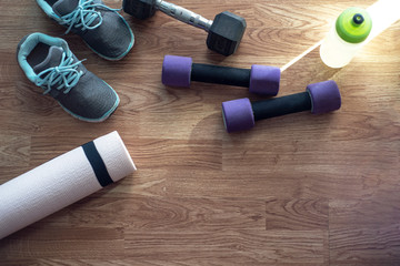 Fitness concept,exercise for losing weight with sport set,sport shoes,mat,dumbbell,drinking bottle...