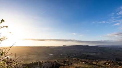 Blue sky with yellow sunset on a plain Tuscany nature landscape