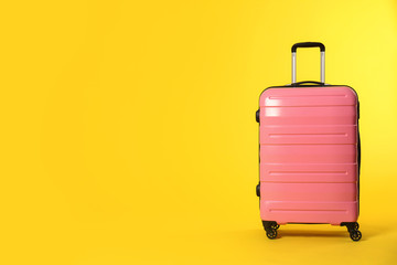 Stylish suitcase on color background. Space for text