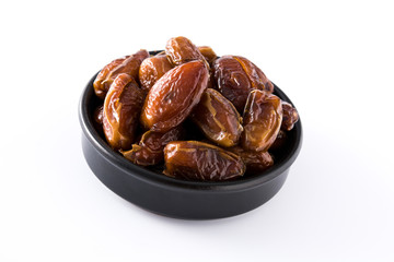 Dates in black bowl isolated on white background