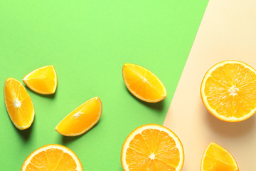 Flat lay composition with ripe oranges on color background. Space for text