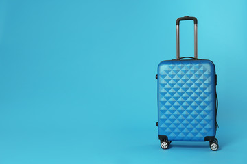 Stylish suitcase on color background. Space for text