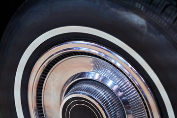 The wheel of a vintage American car. Powerful muscle cars