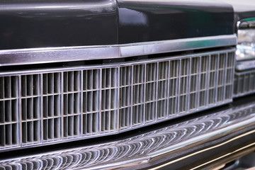 Fototapeta na wymiar Vintage American car. Close-up of headlights and grille