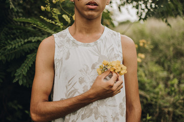teenager in the garden picking yellow flowers