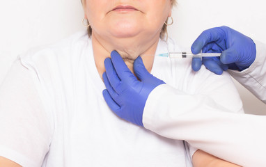 A doctor makes injections of ozone therapy and mesotherapy to a woman in a double chin to get rid of wrinkles and double chins, facial and skin rejuvenation, liposuction, serum