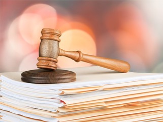 Judge hammer and documents on room background, bokeh background
