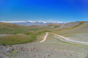 Mongolian Altai. Mountain pass. Scenic valley on the background of the snowcapped mountains....