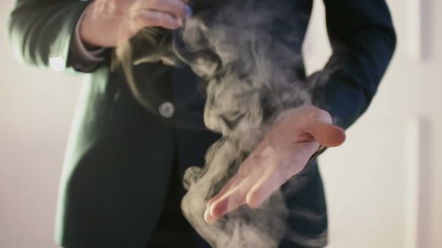 Close-up of Illusionist's hands performing trick with coin