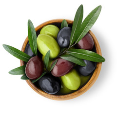 Delicious black, green and red olives with leaves in a wooden bowl, isolated on white background,...