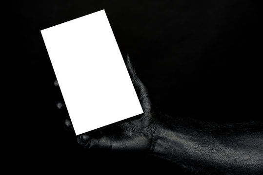 the hand is completely in black paint holding a white sheet with space for the inscription