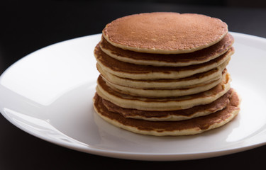 Delicious warm morning pancakes on a white plate
