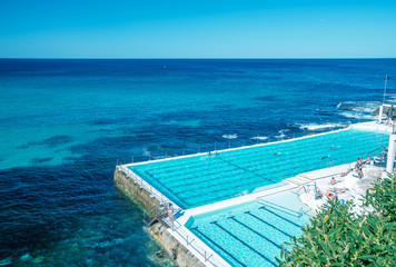 Swimmers enjoy beautiful pool along the sea