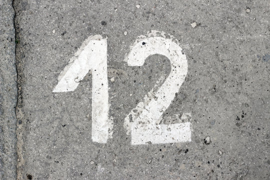 Parking lot asphalt stencil number 12 street sidewalk