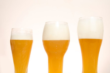 Closeup three beer glasses sorted by height 