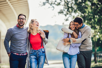 Group of smiling friends in city - travel, vacation and friendship concept