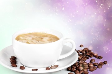 Coffee cup and coffee beans on wooden background