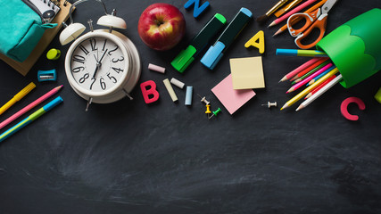 School supplies background flat lay on blackboard, back to school concept