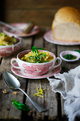Soup with green vegetables and sea bass.
