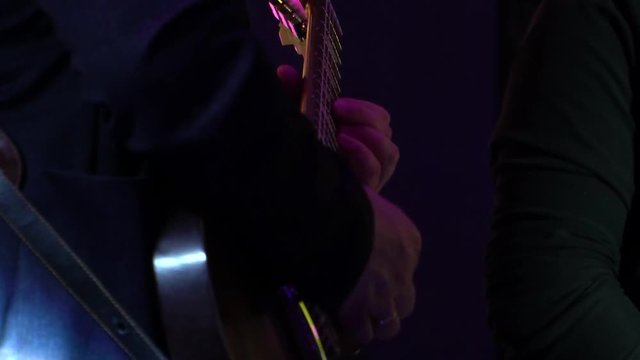 Guitarist at the concert plays electric guitar shape Les Paul
