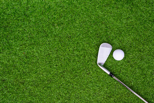 Different golf clubs, balls and tee on the green grass background.Golf set concept.Sport equipment