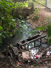 Moscow, Russia - 6/12/2015: Polluted little city stream
