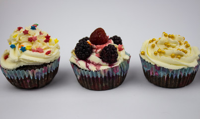 Various Cupcakes with cream on a white background. Copy space