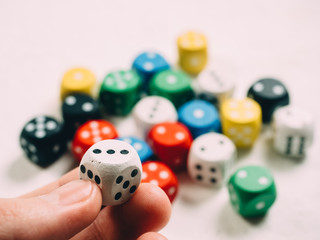 Color dices in hand. Board game casino risk luck