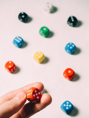 Color dices in hand. Board game casino risk luck