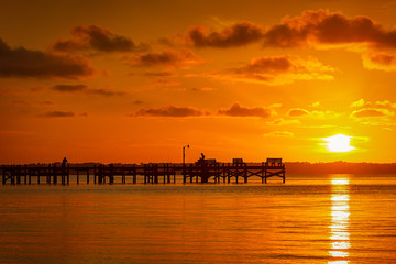 Fototapeta premium Orange Sunset with Dock Silhouette