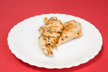grilled chicken fillet on white plate