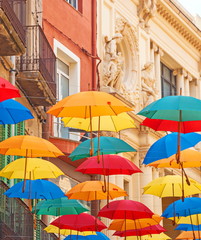Bright colored umbrellas over  street of  Spanish city of Reus
