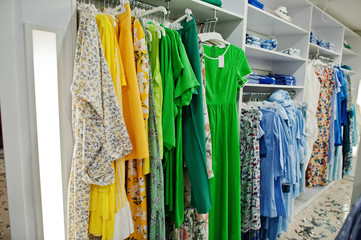 Female green colorful clothing set of on the racks in clothing store brand new modern boutique. Spring summer dress collections.