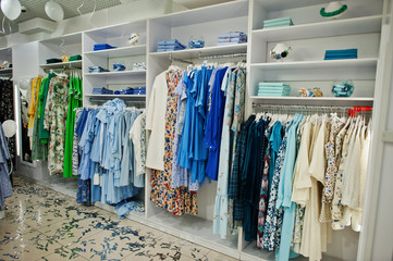 Female blue colorful clothing set of on the racks and shelves in clothing store brand new modern boutique. Spring summer dress collections.