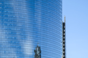 modern office building glass facade with reflections