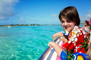 Happy beautiful fashion family, children and parents, dressed in hawaiian shirts, enjoying day trip with speed boat