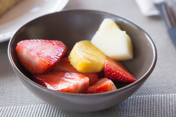 Fruit salad on dark bowl