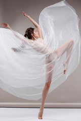 Beautiful ballet-dancer, modern style dancer posing on studio background © Pandorabox